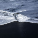 Wavebreak on volcanic sand